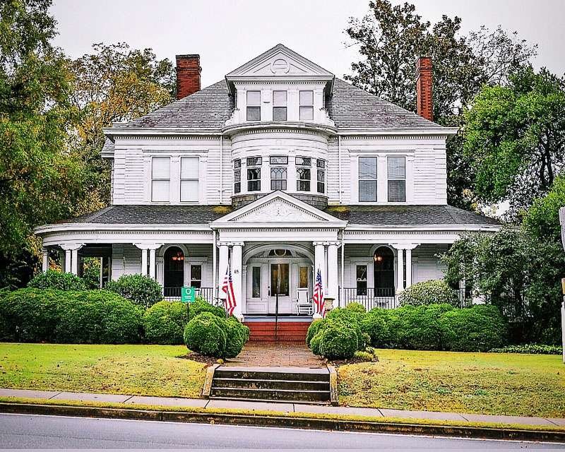 Historic Marietta home with wrap around porch, intricate architectural details. 